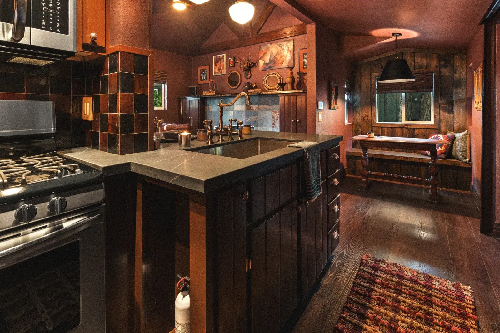 The open concept kitchen - dining - living area makes the tiny cabin feel more spacious.