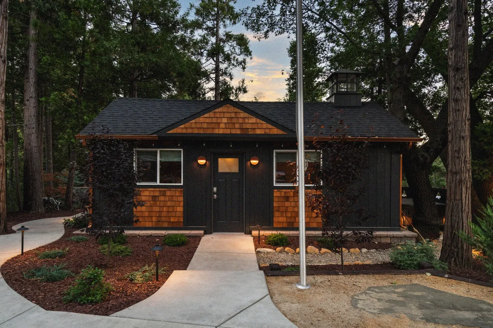 The Coulter Pine cabin is an old converted school house, complete with the bell tower on top. Lights throughout the property illuminate your walkways in the evening.