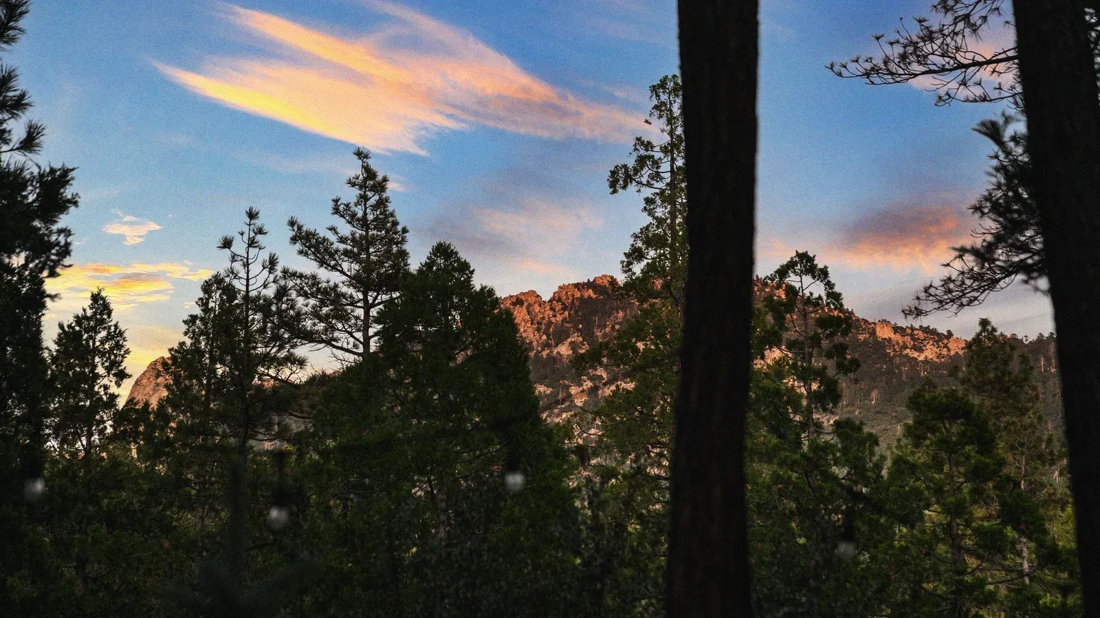 At dusk, the sky paints the surrounding mountains pink.