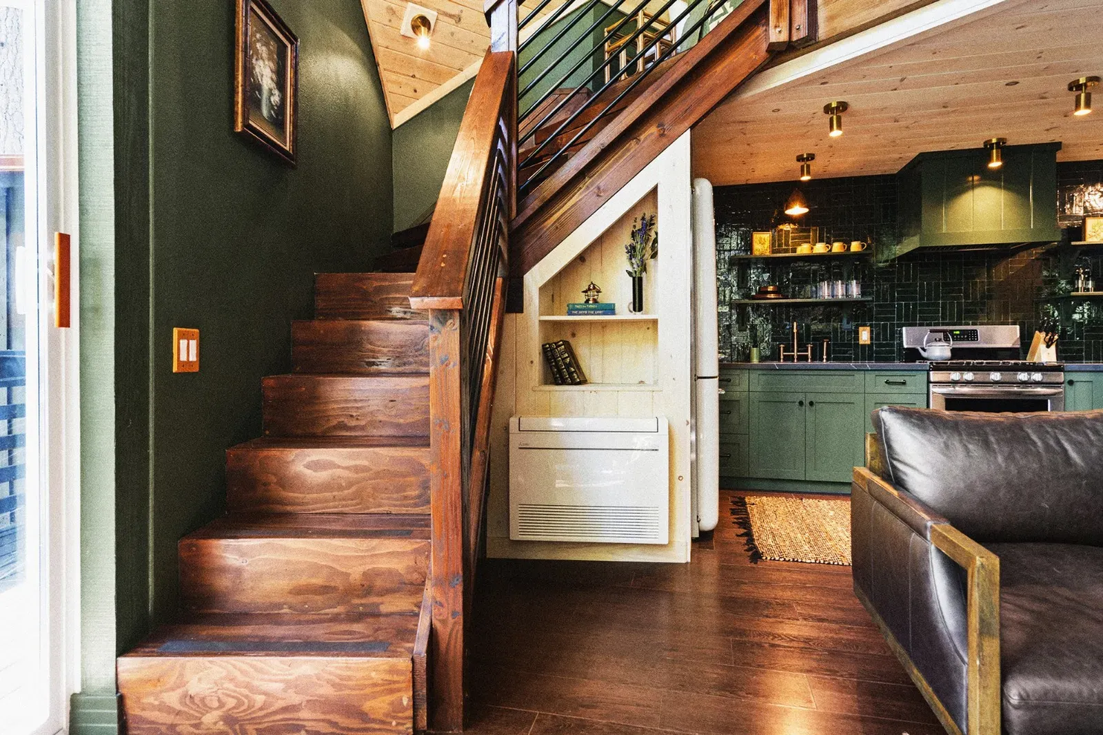 The stairs lead to the upstairs loft, which offers a daybed and lounge space.