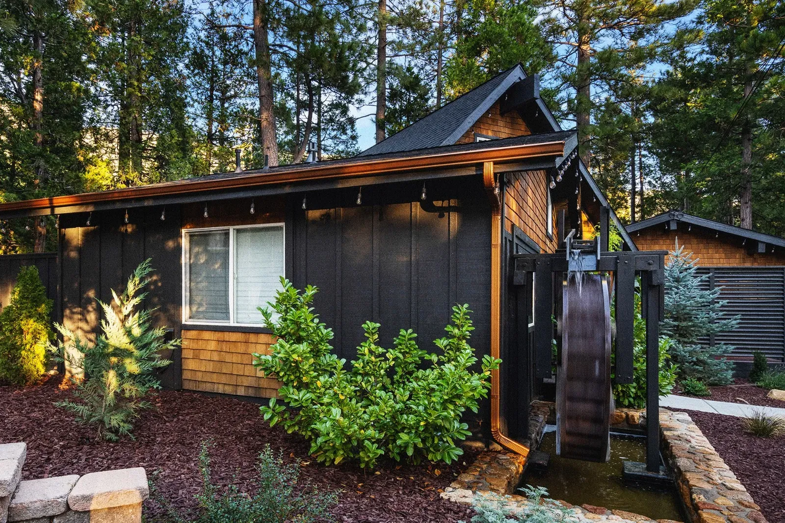 A working water wheel outside is a unique design feature and adds a relaxing ambiance to the property.