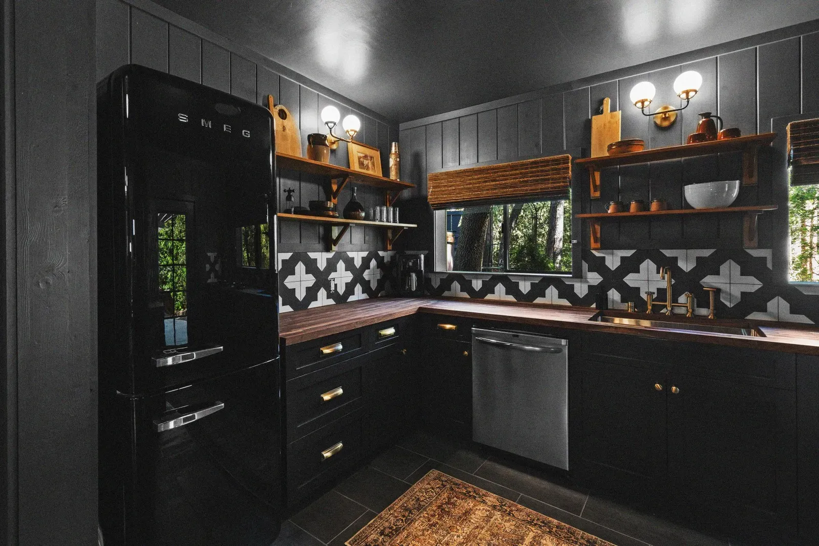 The full kitchen includes a Smeg fridge, stove, dishwasher, pots & pans, cooking utensils, a tea pot, and more - everything you need to cook delicious meals in your cabin.