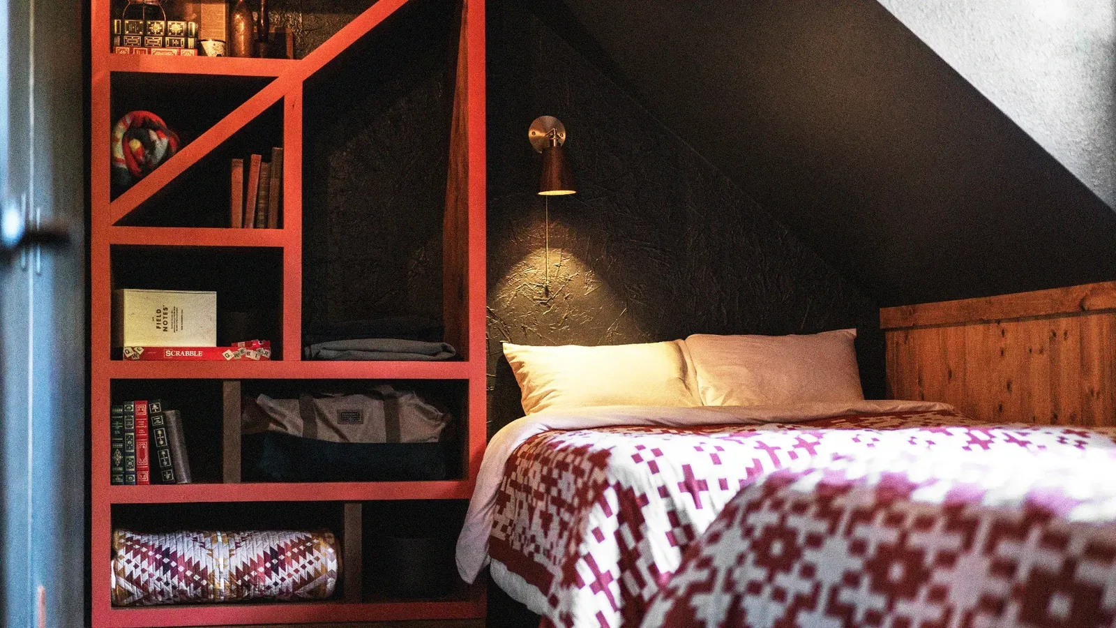 A custom red bookcase is a stand-out feature in the room, and is full of treasures for you to explore.