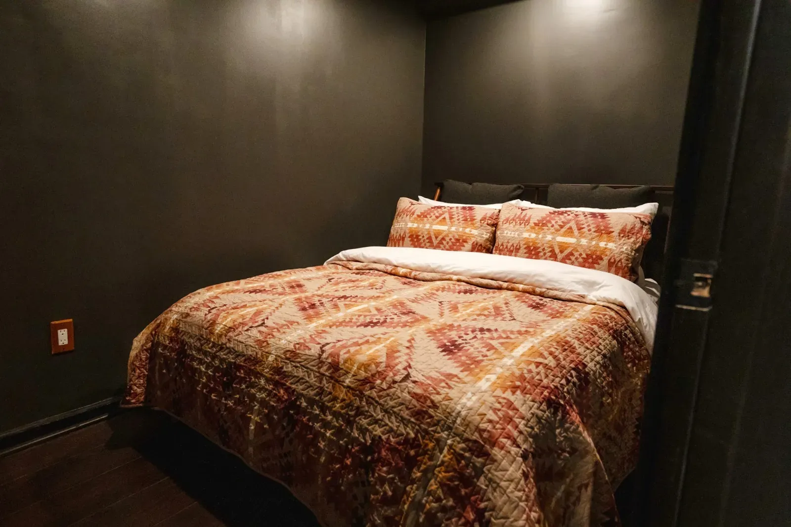 The downstairs bedroom is cozy with a queen bed.
