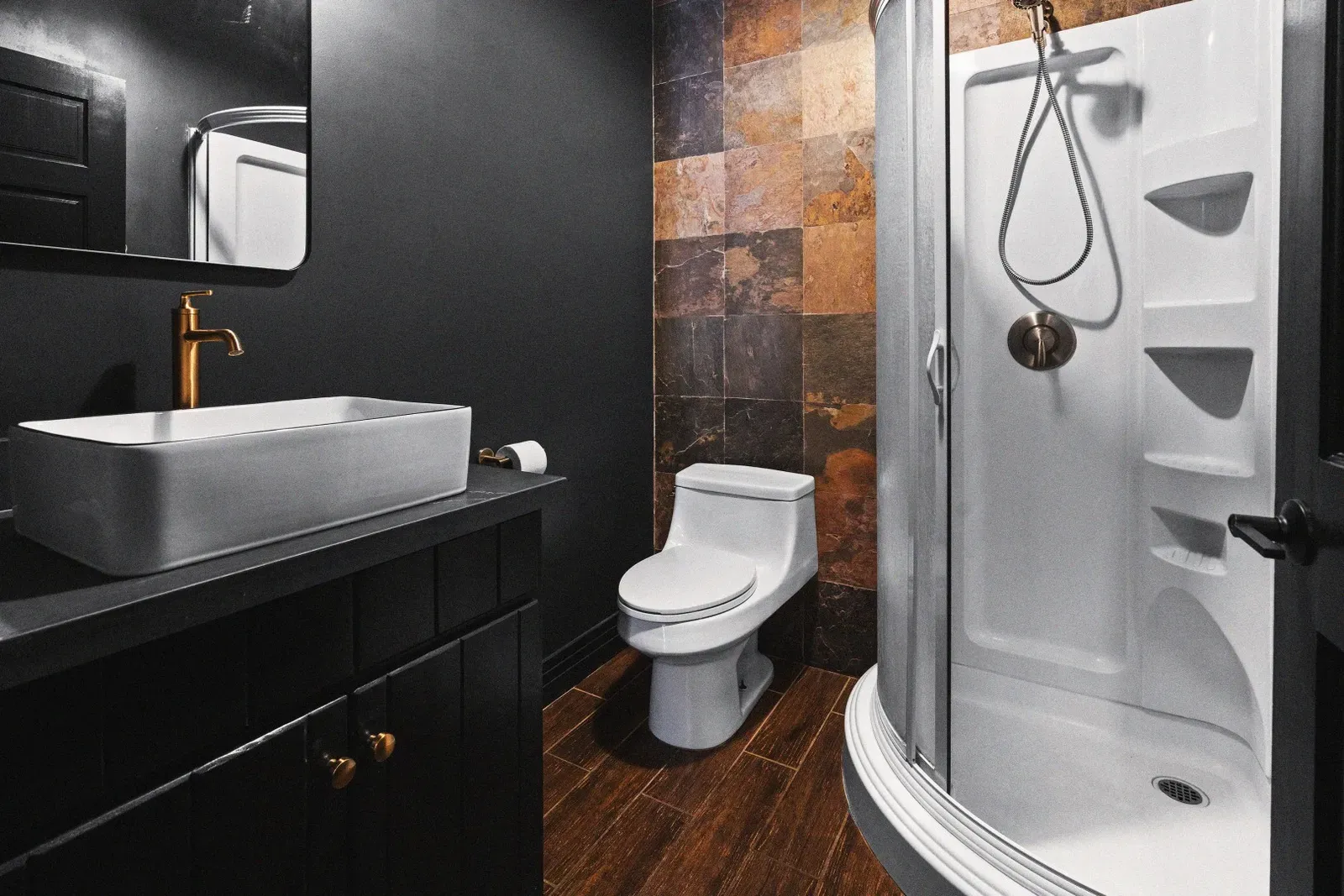 The downstairs bathroom features a standing shower and complimentary toiletries.