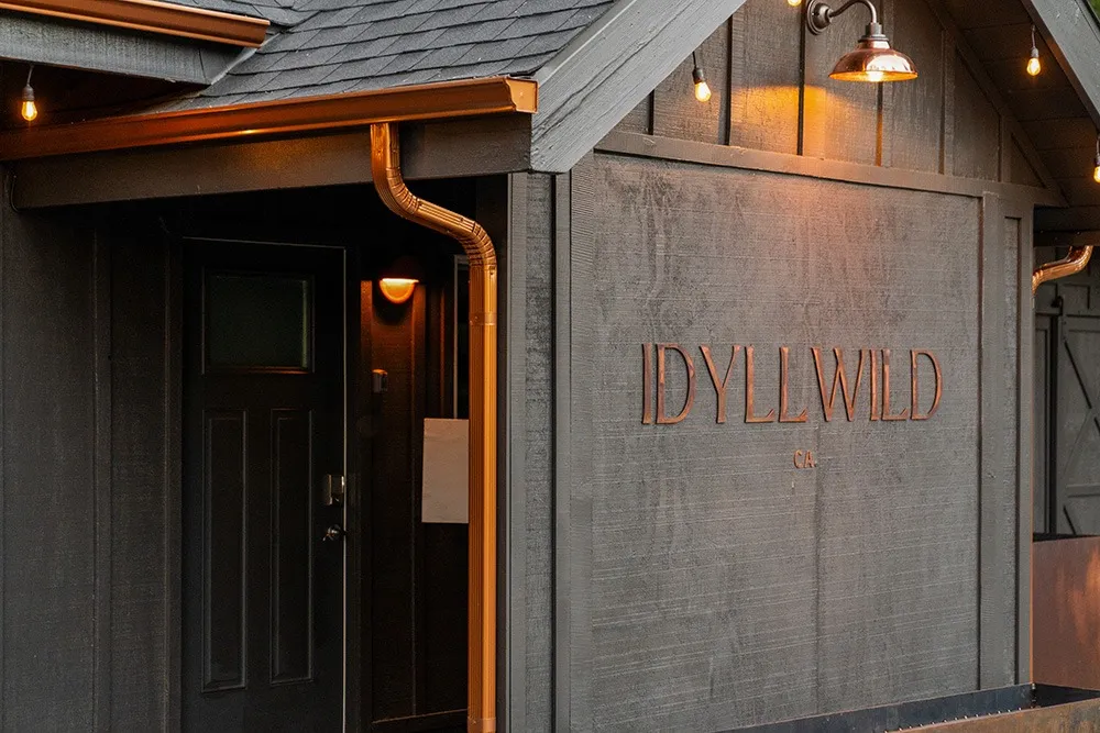 Idyllwild sign on the exterior of the Ursus Cabin by Freewyld
