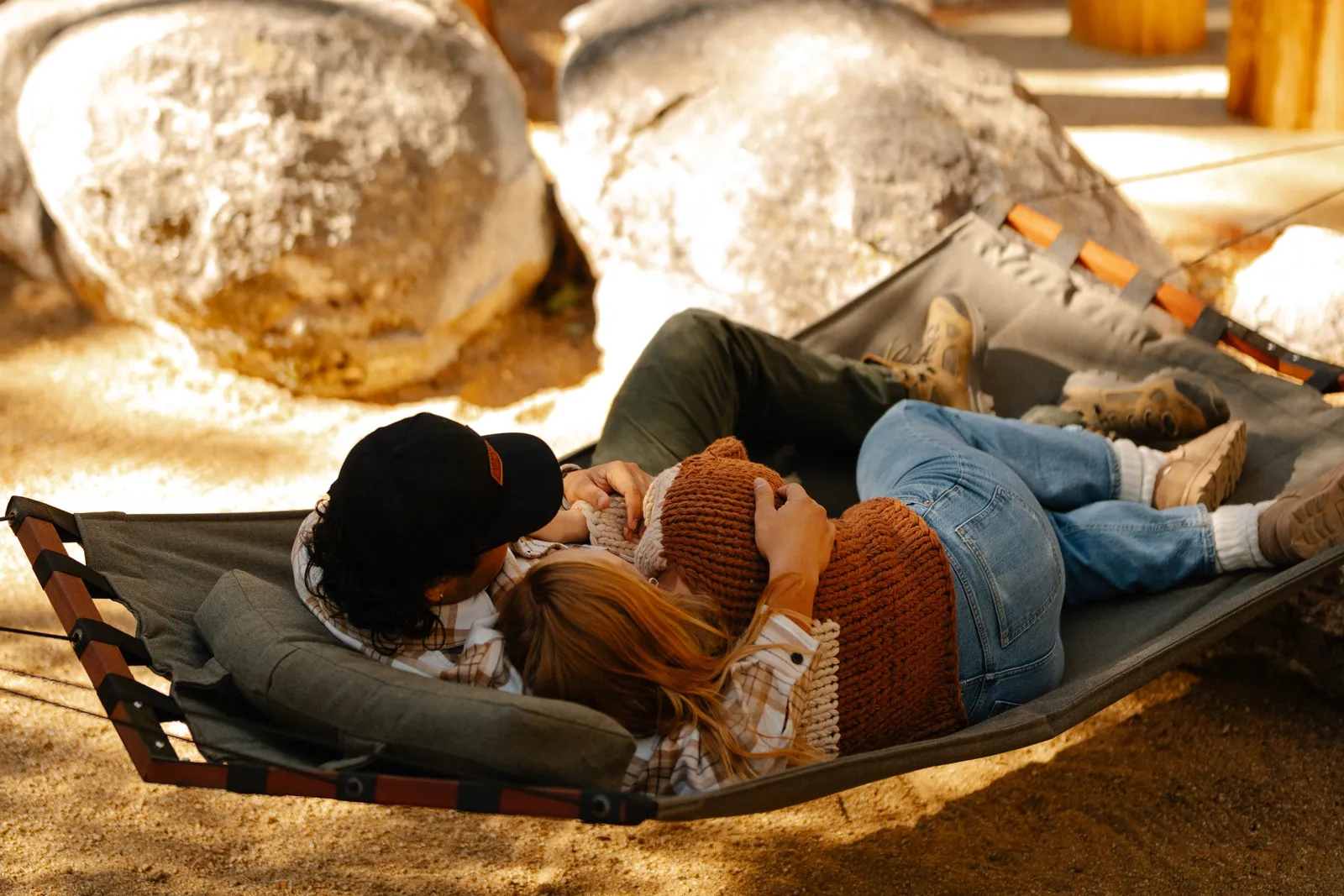 A guest relaxing inside a warm, lamp-lit Freewyld cabin in Idyllwild
