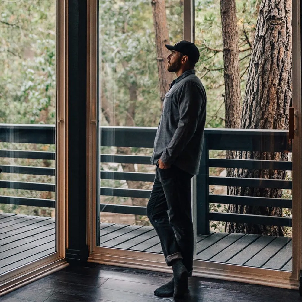 Freewyld founder relaxing by the fire inside a cabin in Idyllwild, California